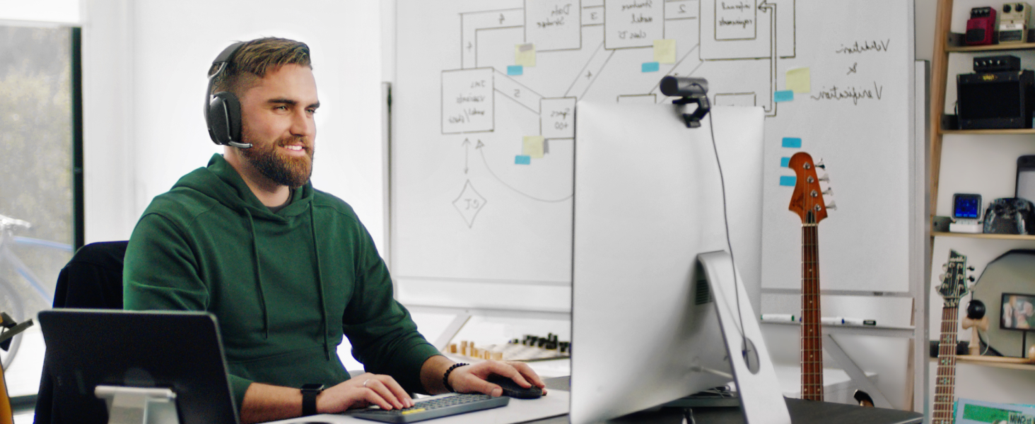 A man working on a computer and wearing Zone Vibe 100 Graphite
